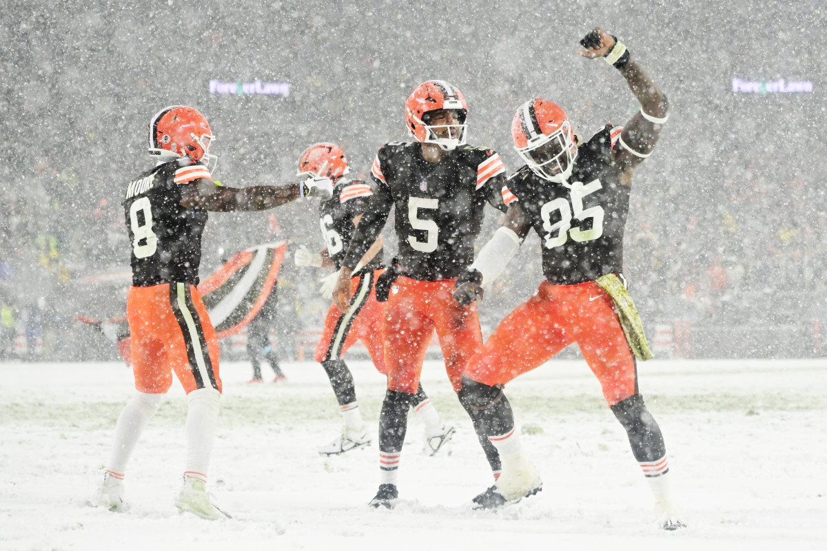 Browns players Moore and Winston celebrating in snow